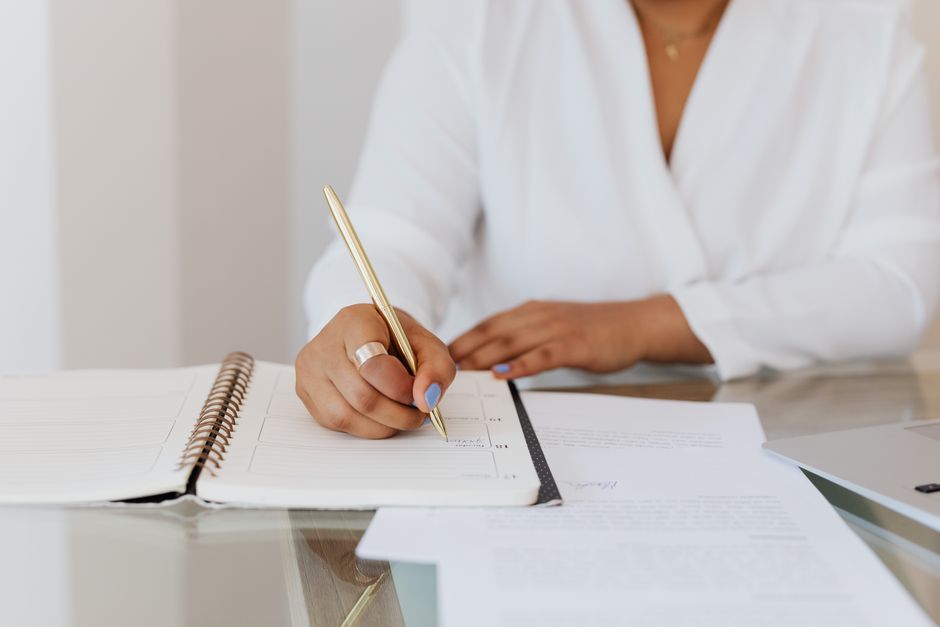 Wedding planner organizing and working on details at a desk