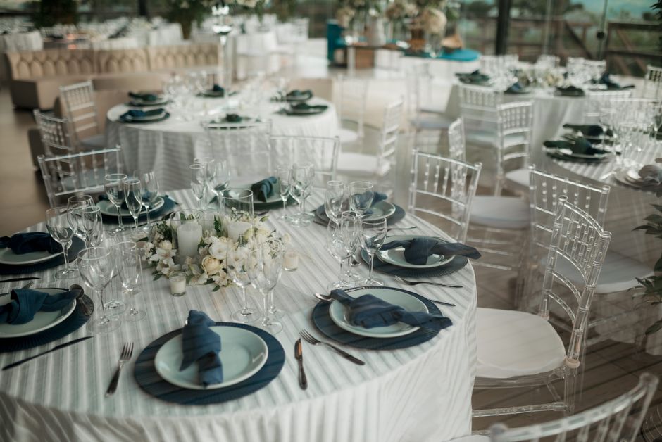 Elegant wedding reception table setting with floral centerpieces and soft candles
